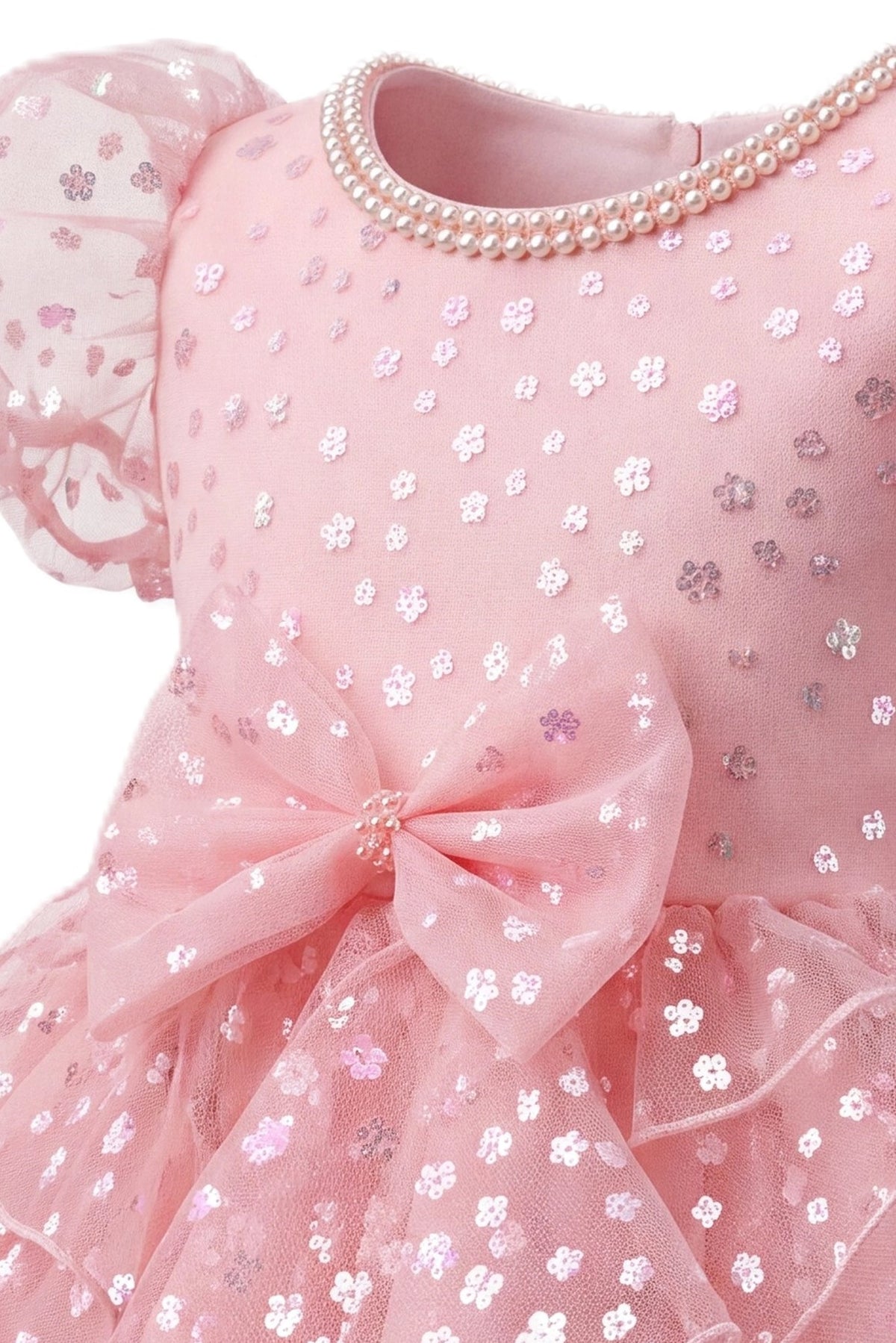 Detailed a flower-patterned waist bow complements the Blush kids dress.
