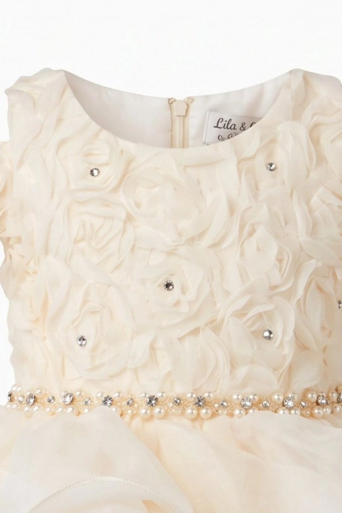 Detailed cascading skirt ruffles complements the Champagne kids dress.