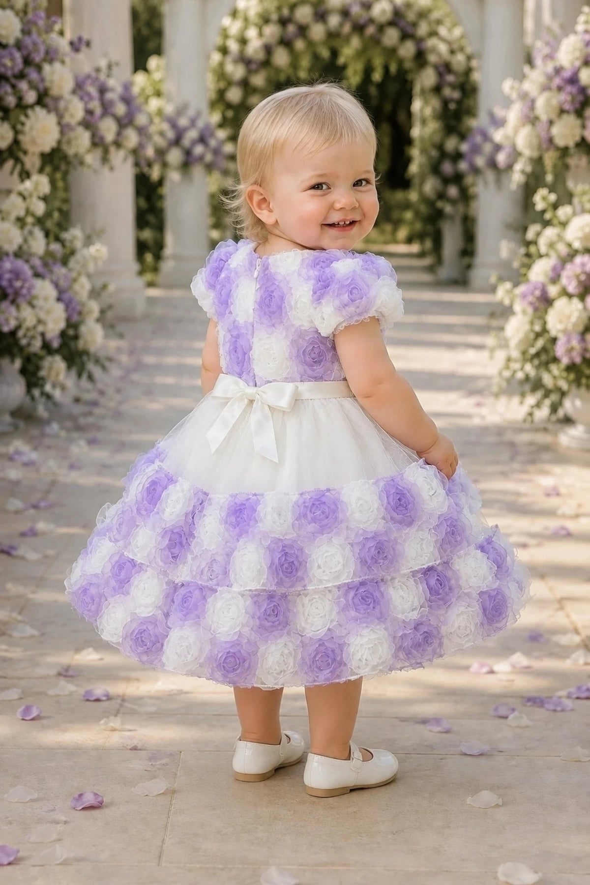 Tied at the back, the Lilac kids dress features a large bow.