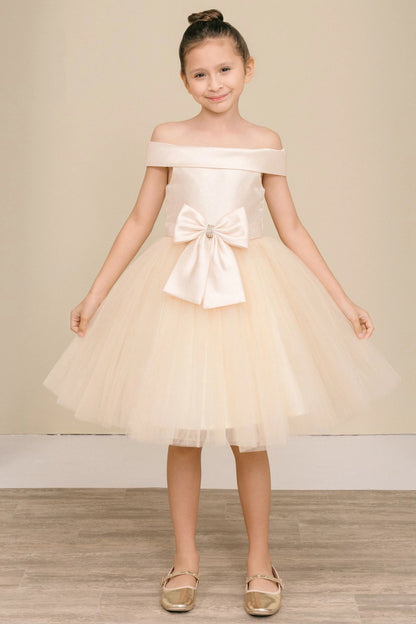 Champagne flower girl dress features large front bow above the layered tulle skirt.
