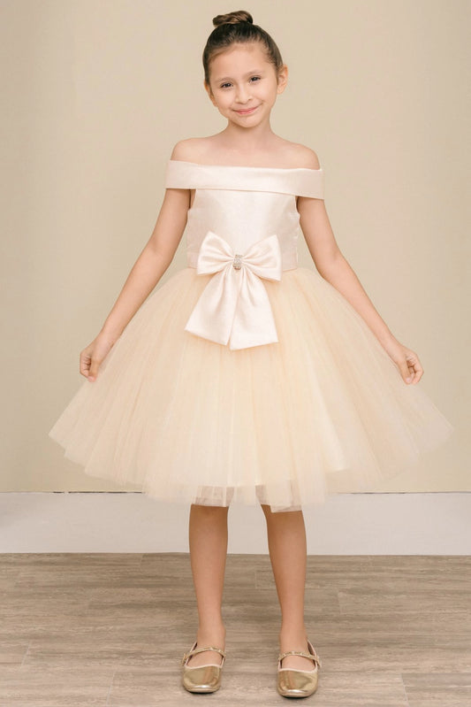 Champagne flower girl dress features large front bow above the layered tulle skirt.
