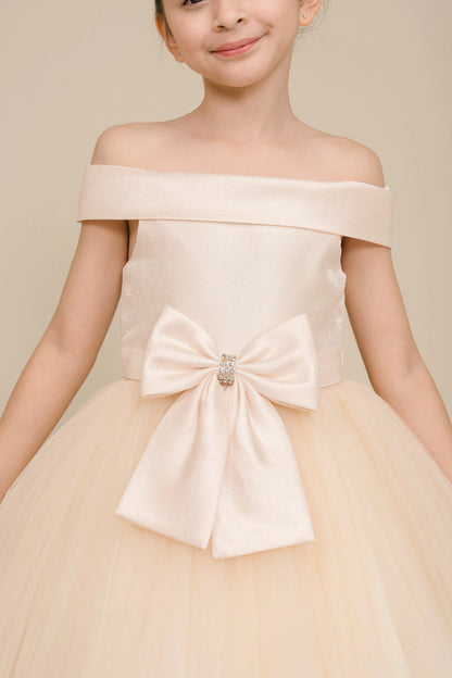 Visible on this Champagne flower girl dress: jeweled front bow beneath the off-shoulder neckline.