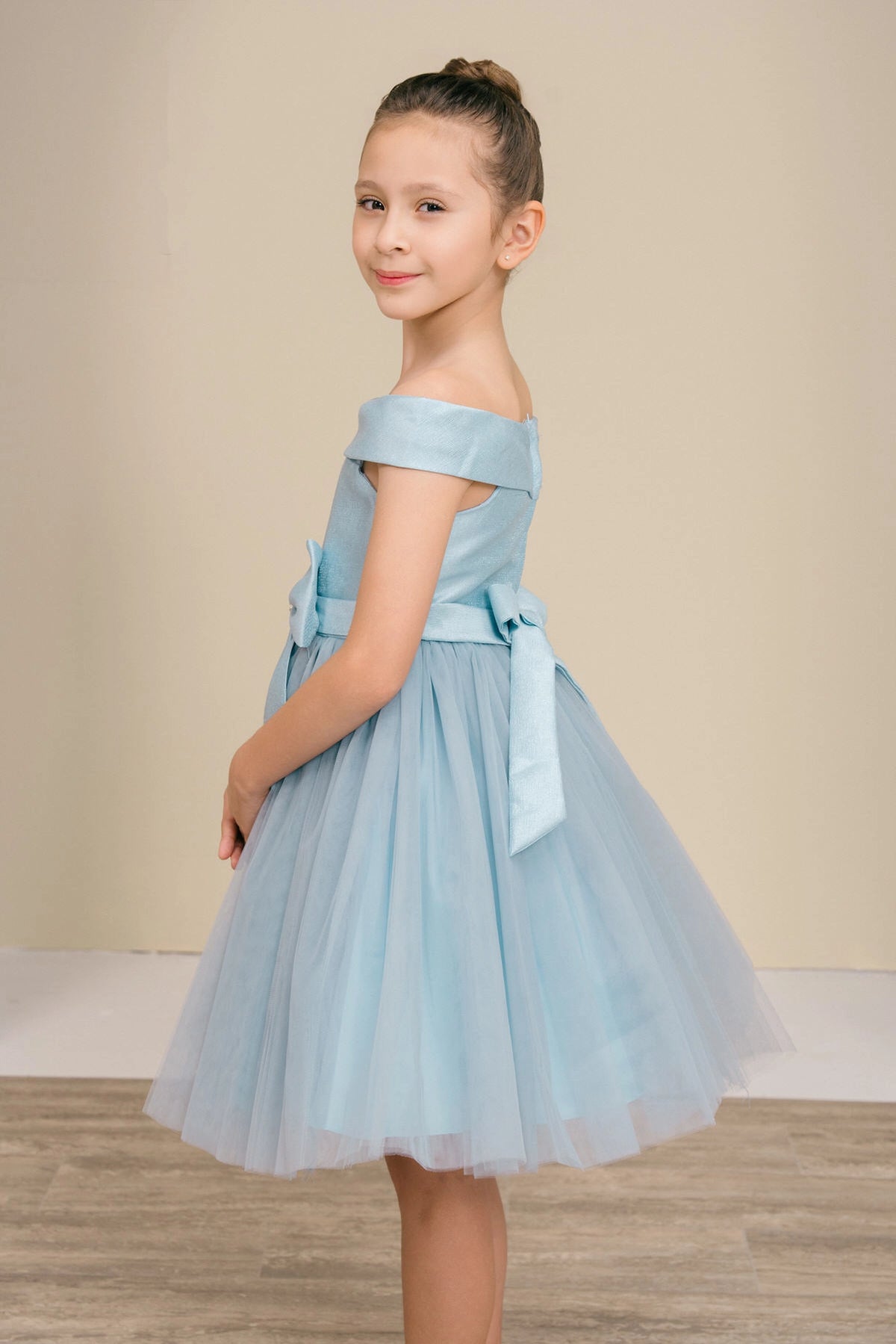 Featuring off-shoulder band above a flared skirt on the Dusty Blue flower girl dress.