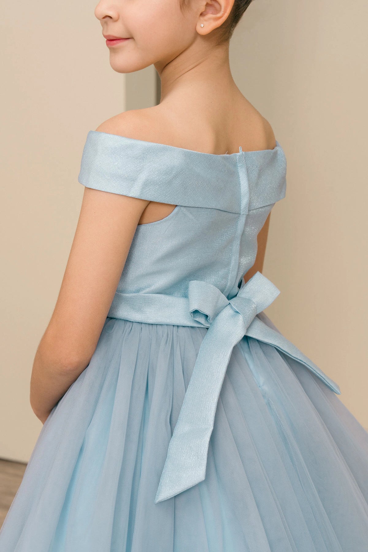 Details of the Dusty Blue flower girl dress include zipper and sash bow at the back.