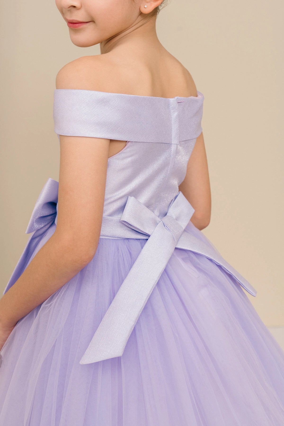 Details of the Lilac flower girl dress include off-shoulder band and back sash ties.
