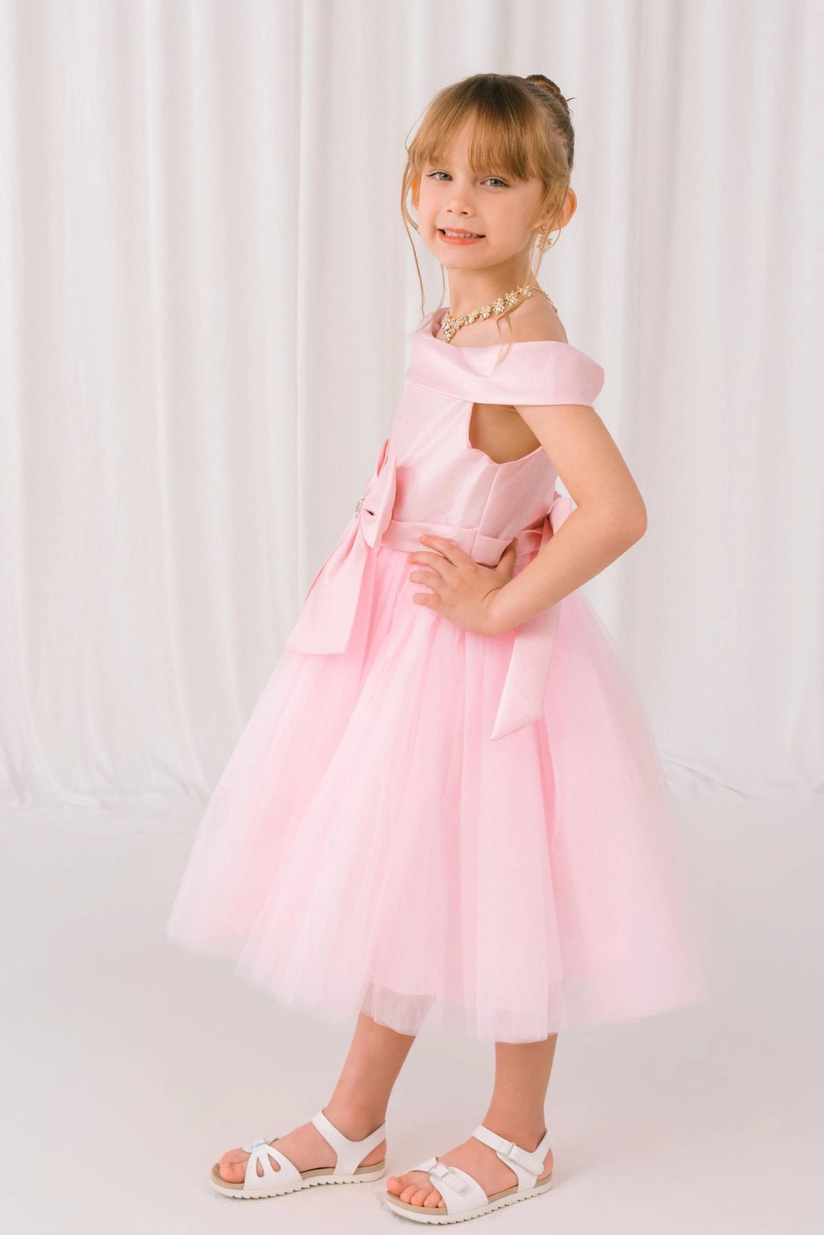 Featuring layered tulle skirt below the satin bodice on the Pink flower girl dress.