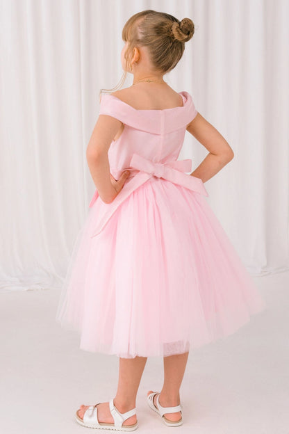 A Pink flower girl dress showing back sash bow above the full tulle skirt.