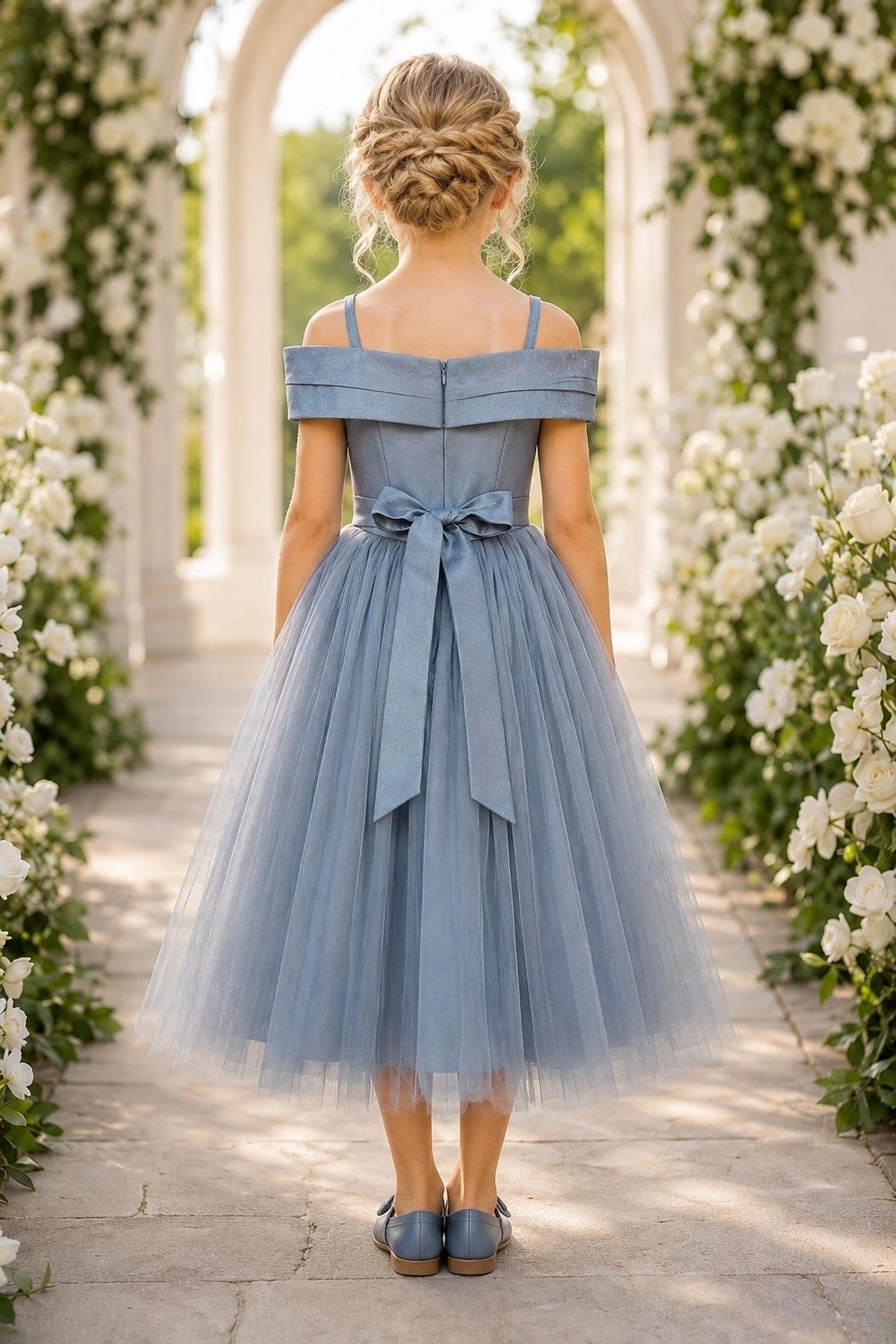 Tied at the back, the Dusty Blue kids dress features a large bow.