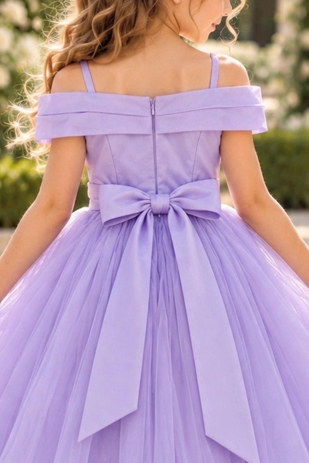 Finished with a back bow, this Lilac kids dress shows its rear construction.