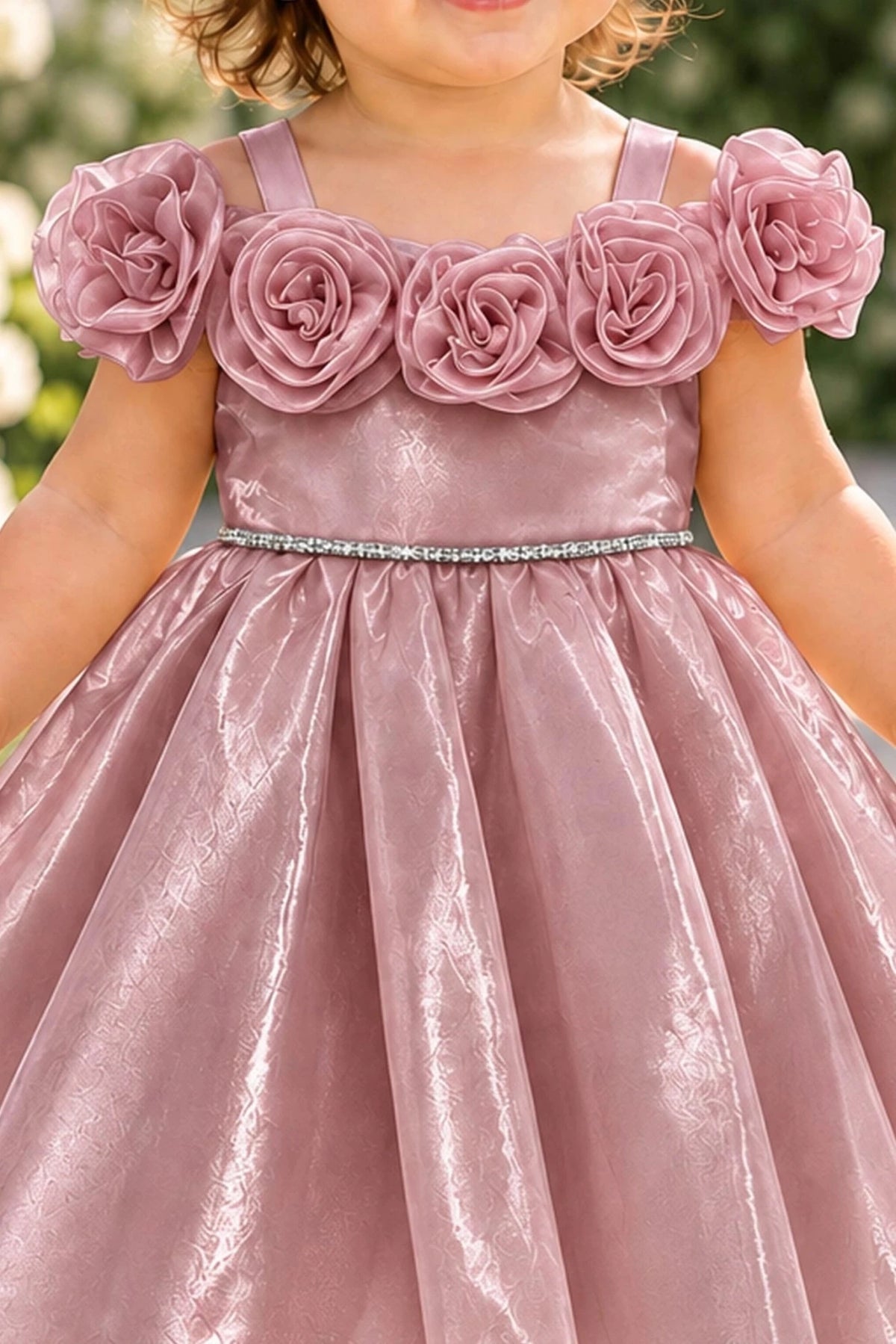 Layered shaping highlights rosettes framing the neckline on the Dusty Rose kids dress.