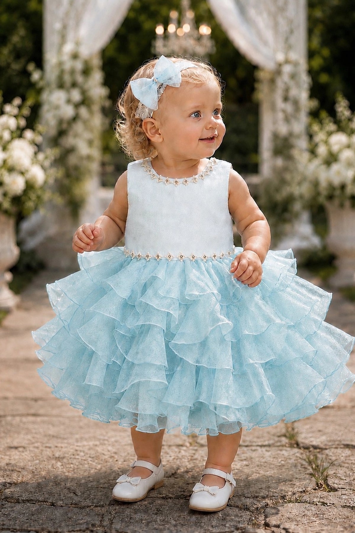 Showcasing cascading ruffled skirt layers, this Blue kids dress has a full skirt.