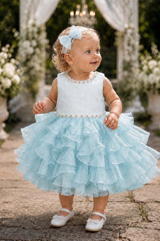 Showcasing cascading ruffled skirt layers, this Blue kids dress has a full skirt.