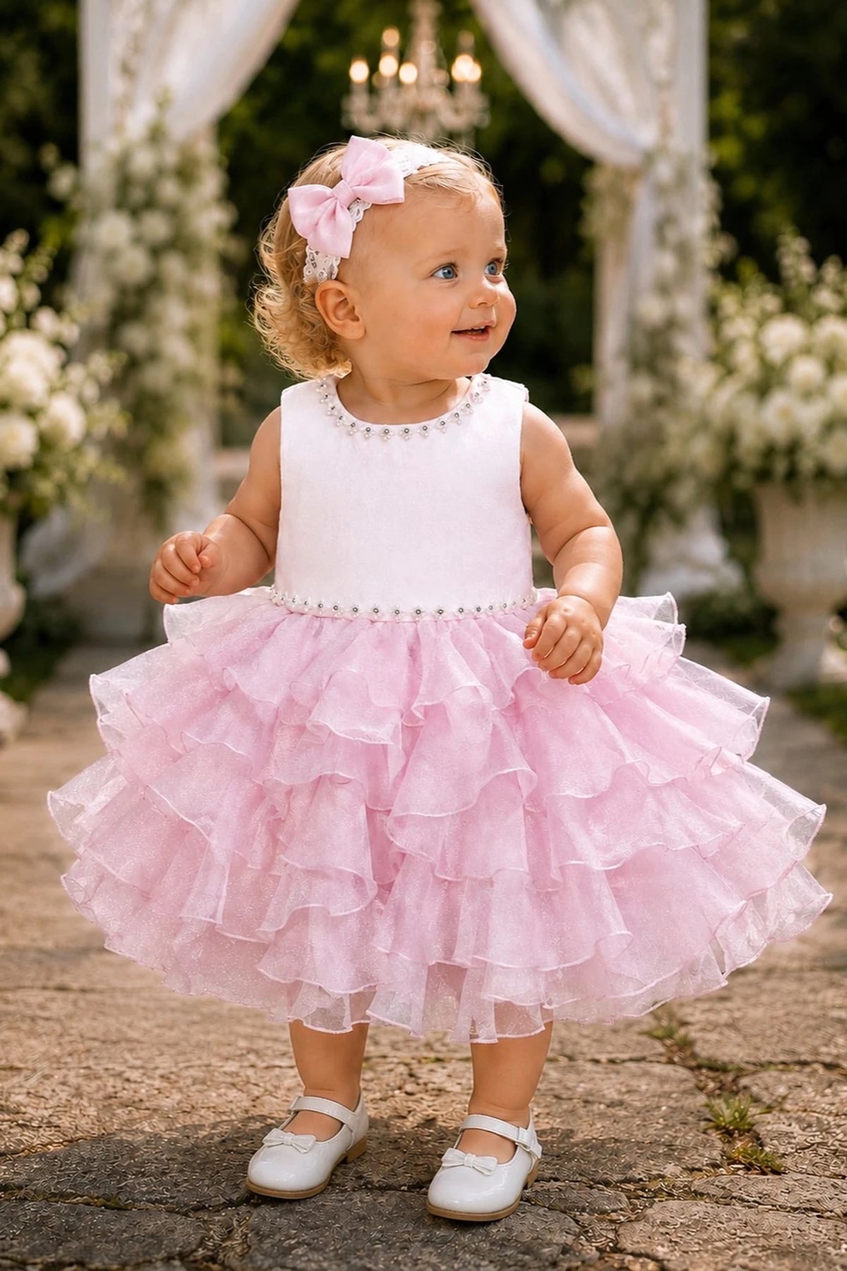 Showcasing cascading ruffled skirt layers, this Pink kids dress has a full skirt.