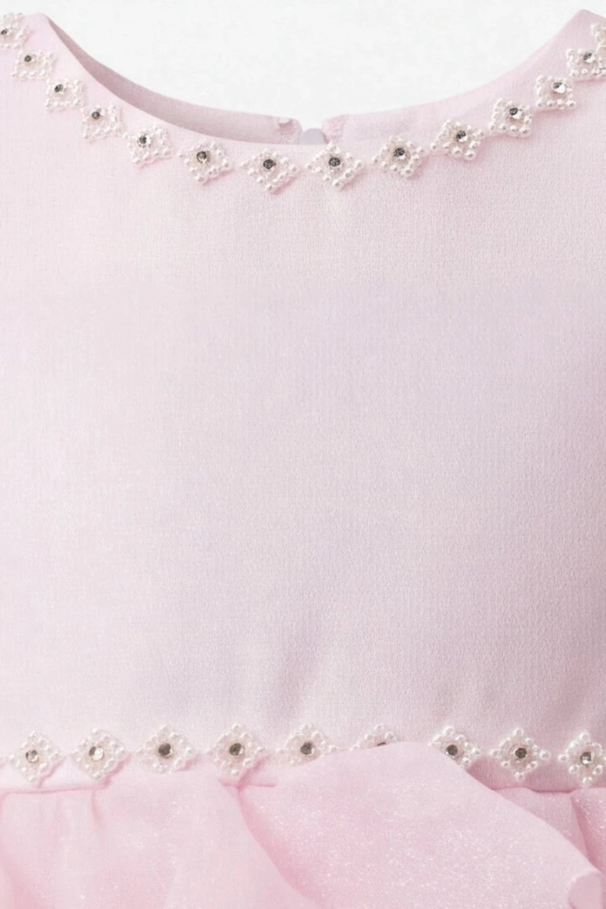 Detailed decorative trim at the neckline complements the Pink kids dress.