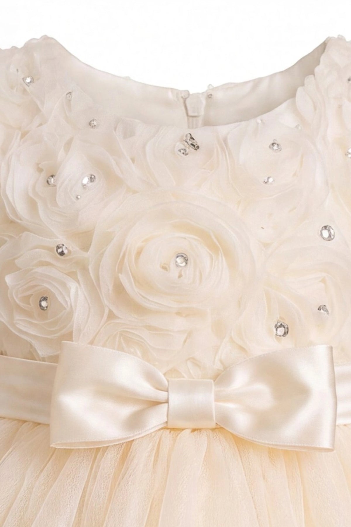 Detailed a ruffled tulle hem complements the Champagne kids dress.