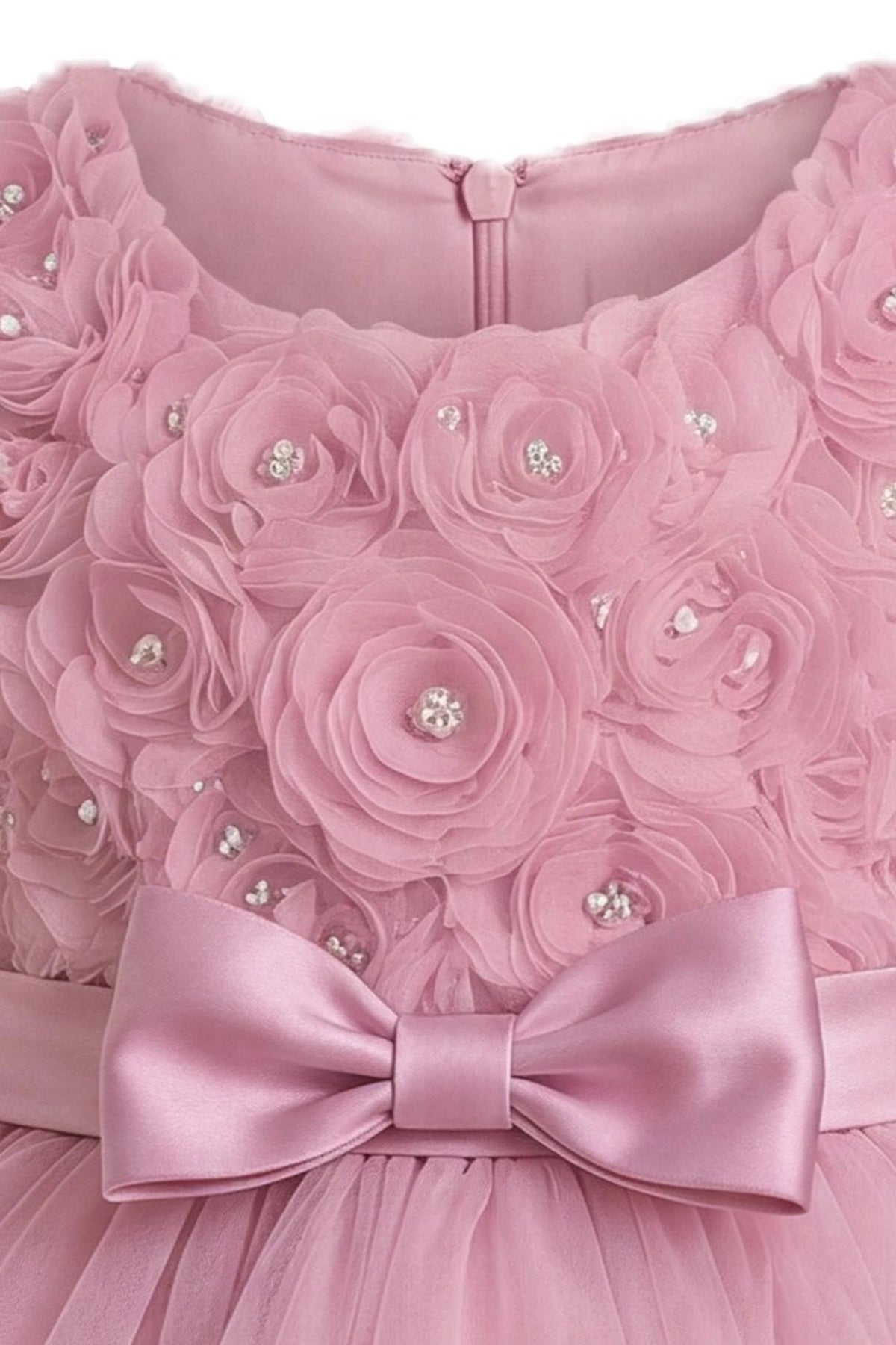 Detailed a ruffled tulle hem complements the Dusty Rose kids dress.
