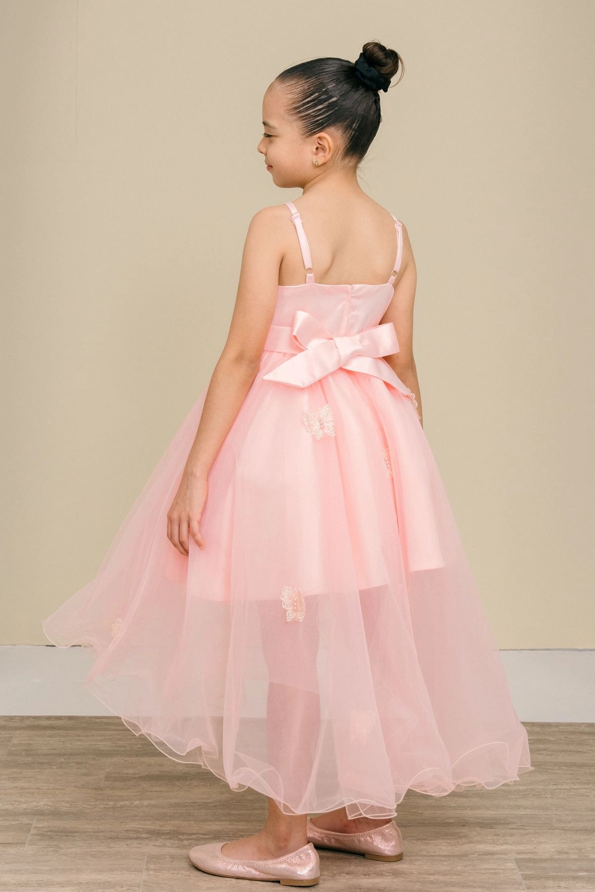 Showcasing with a large bow above a high-low skirt, this Blush kids party dress displays elegant detail.