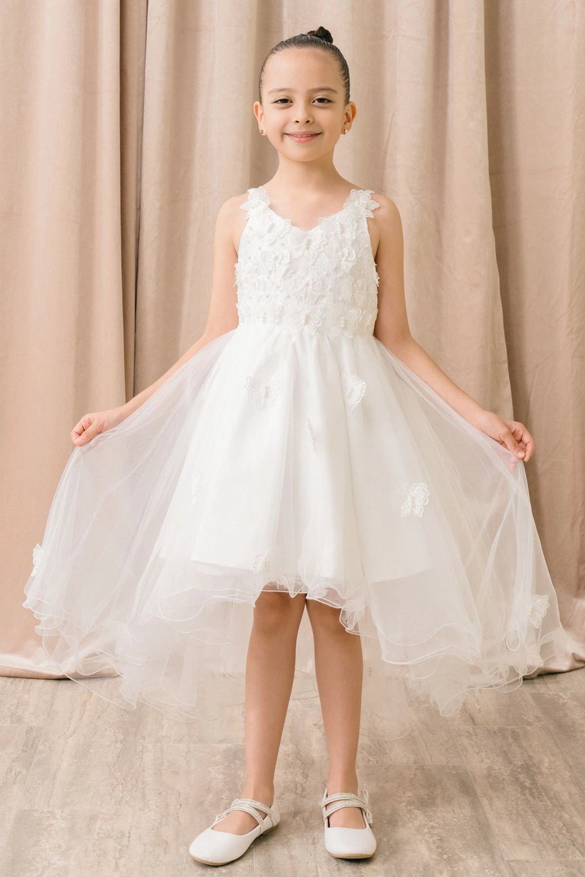 Accented three-dimensional bodice flowers adds character to this White kids party dress.