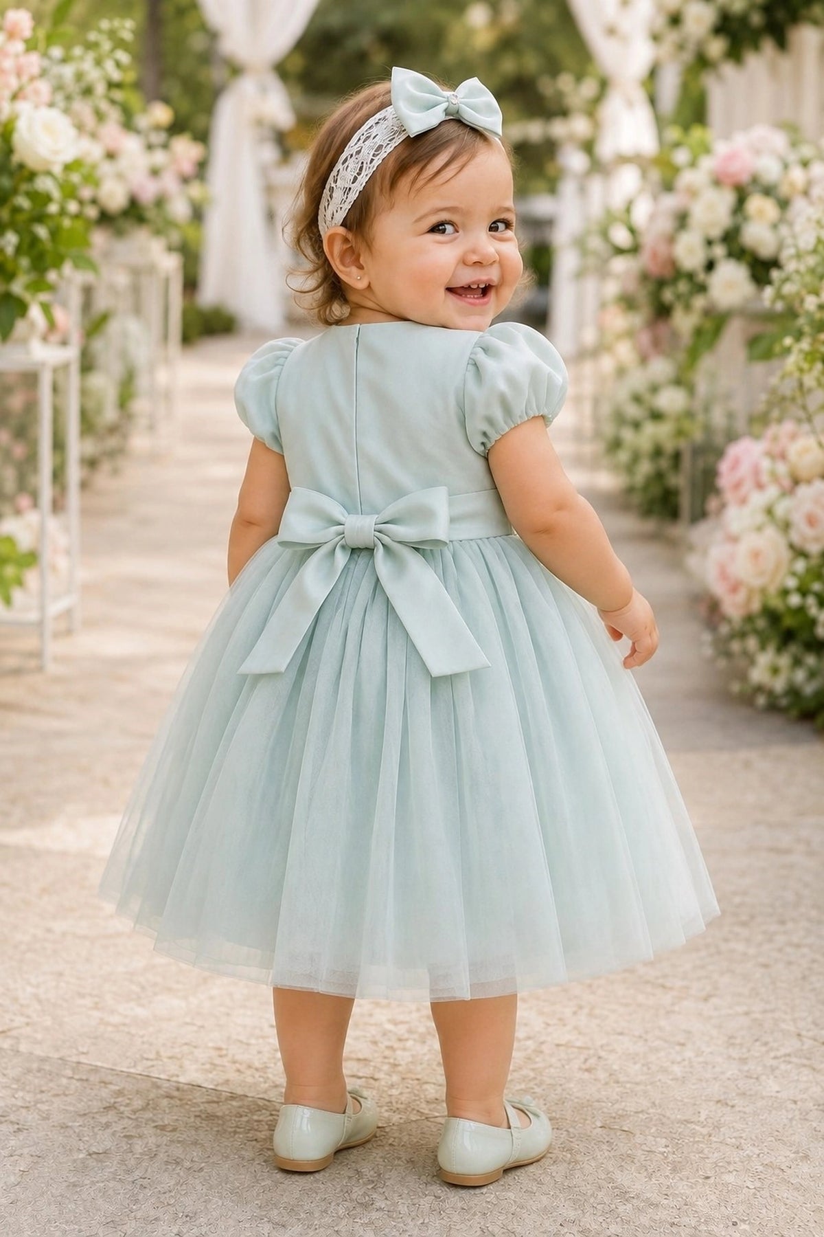Tied at the back, the Sage kids dress features a large bow.