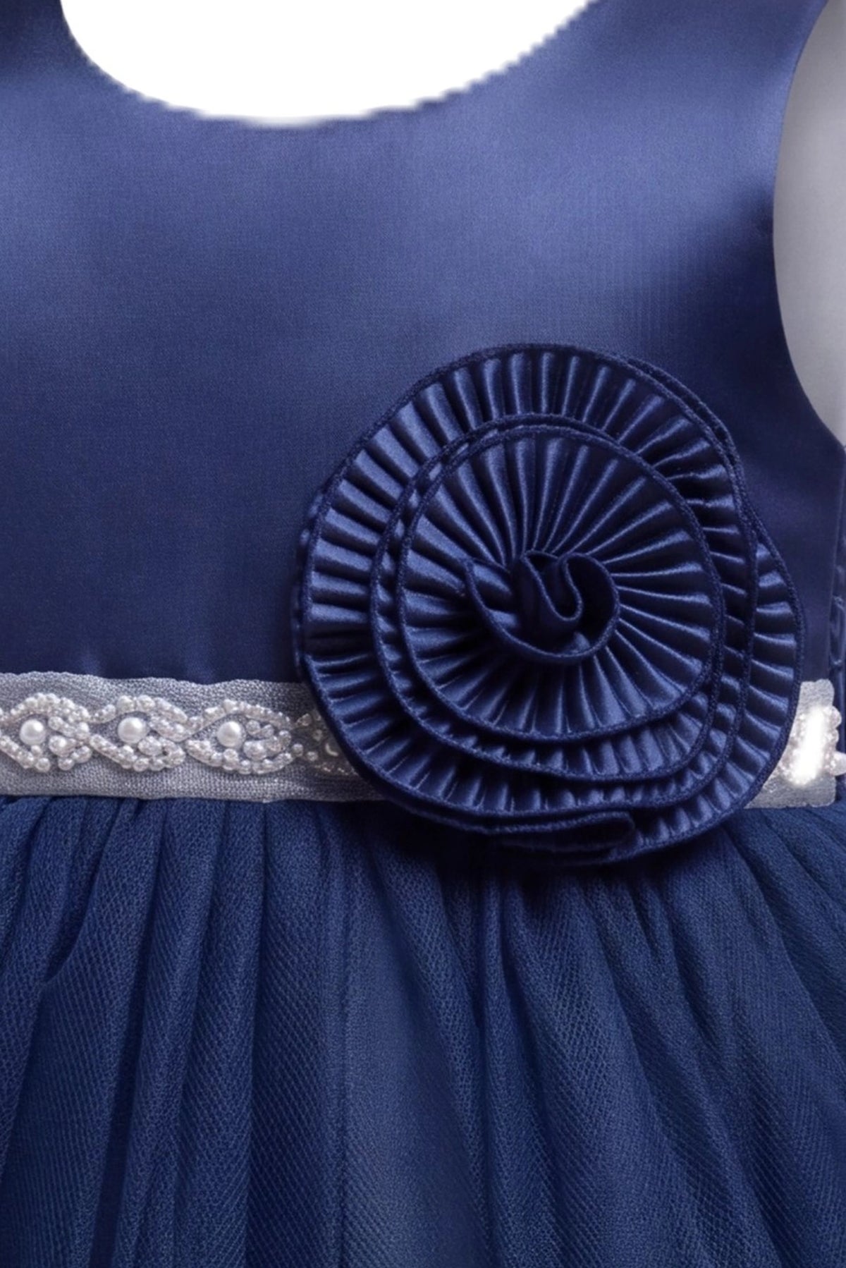 Detailed a pleated rosette at the waist complements the Navy kids dress.