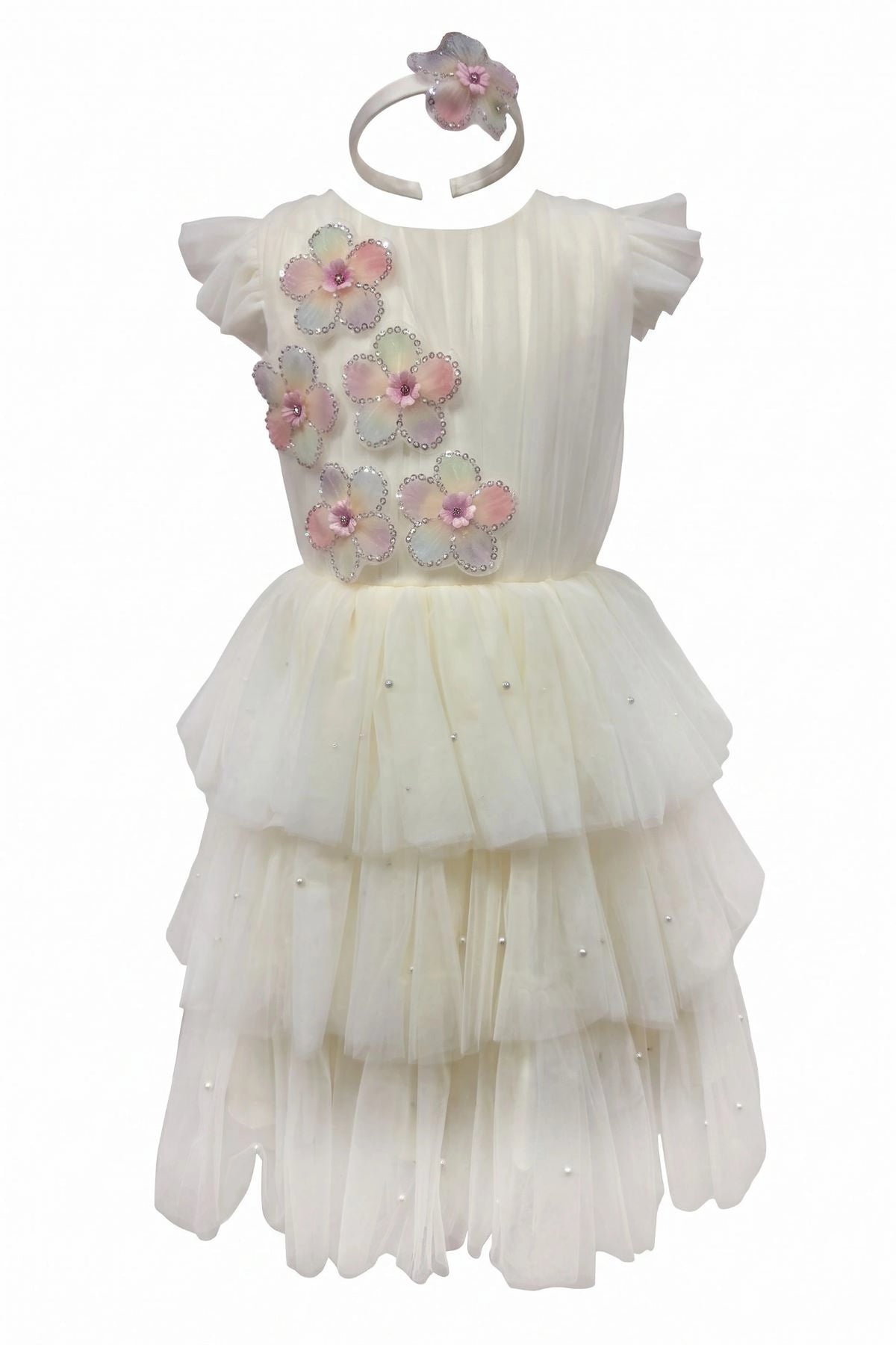 Layered shaping highlights three-dimensional flower appliques on the Champagne kids dress.