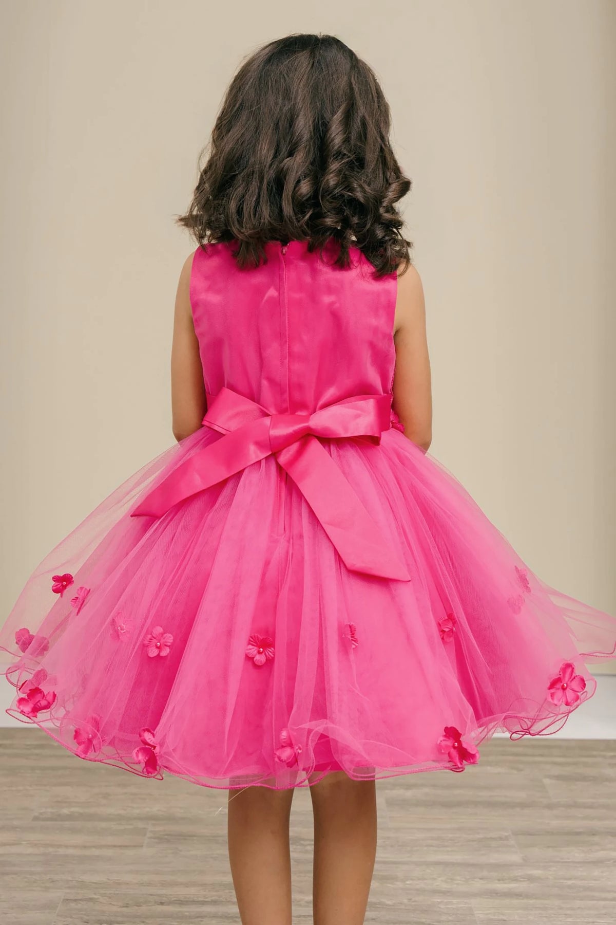 Fuchsia flower girl dress with a large bow.