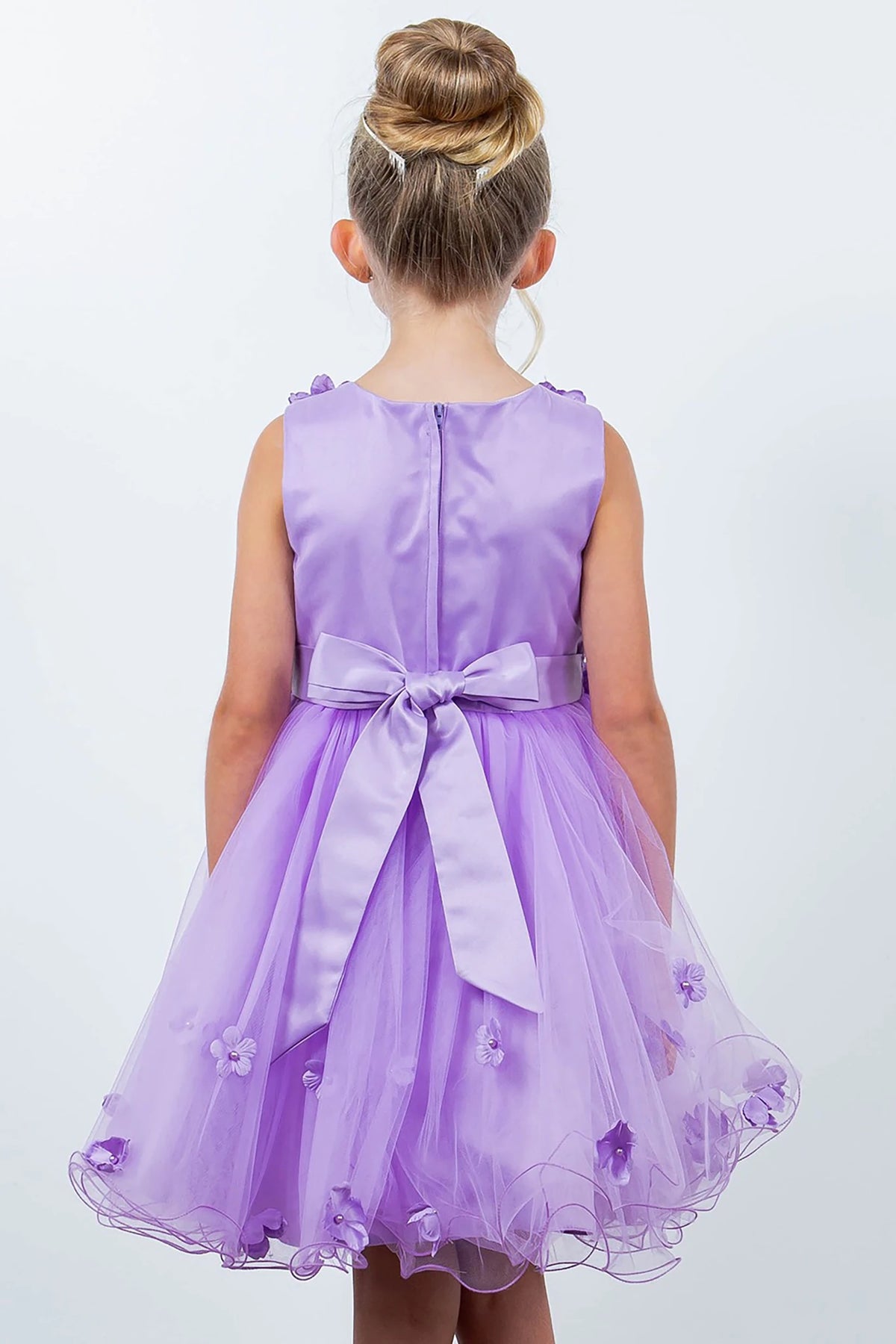 A lilac flower girl dress with a bow.