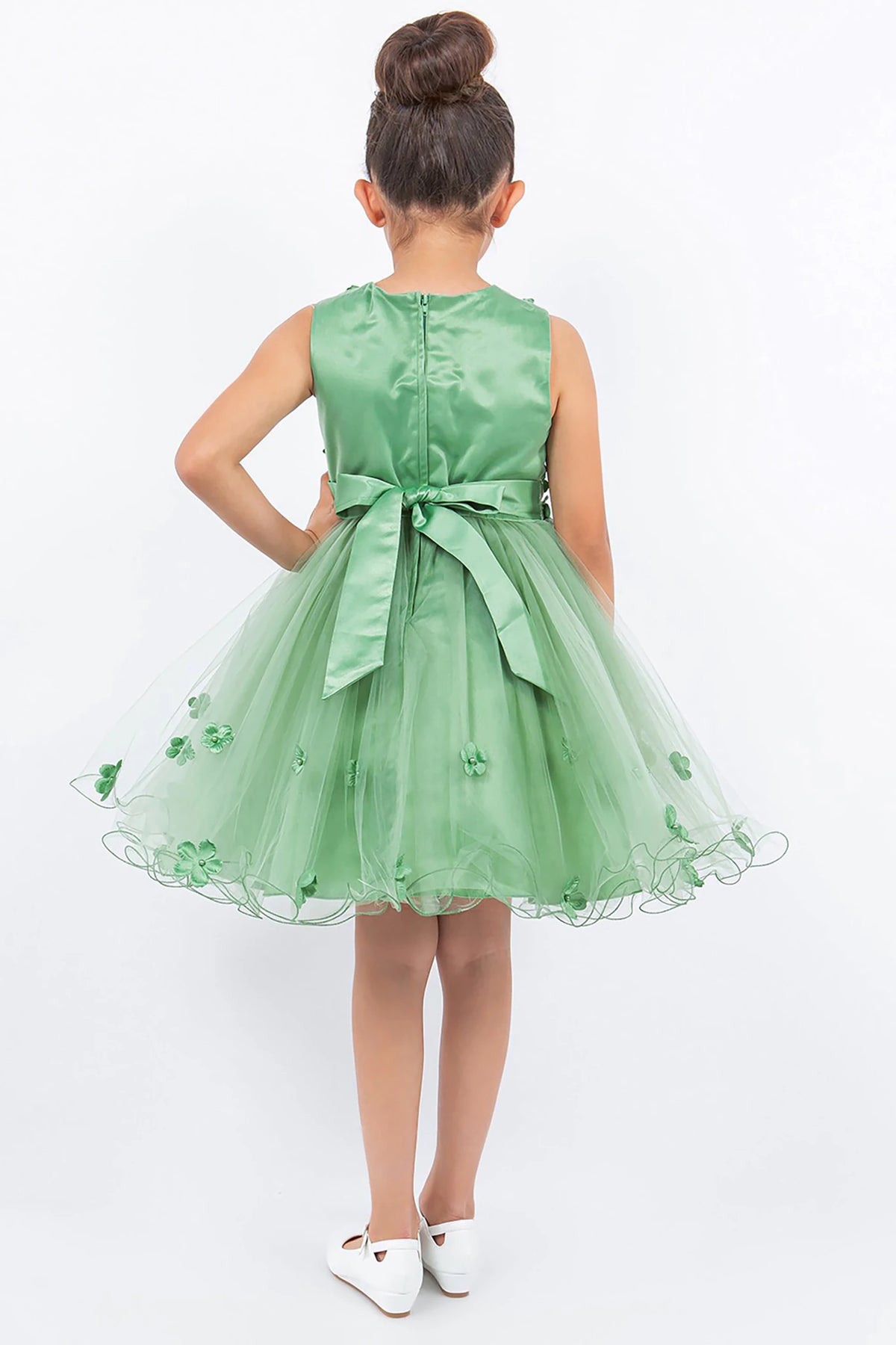 A green flower girl dress with floral details.