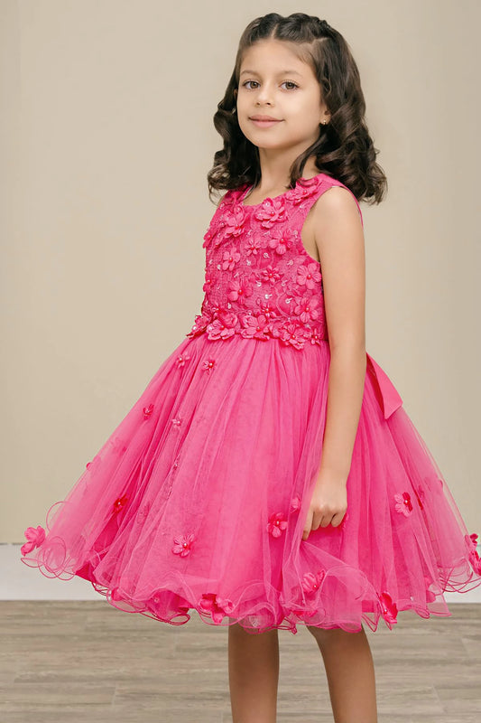 Young girl wearing a fuchsia floral dress on a neutral background