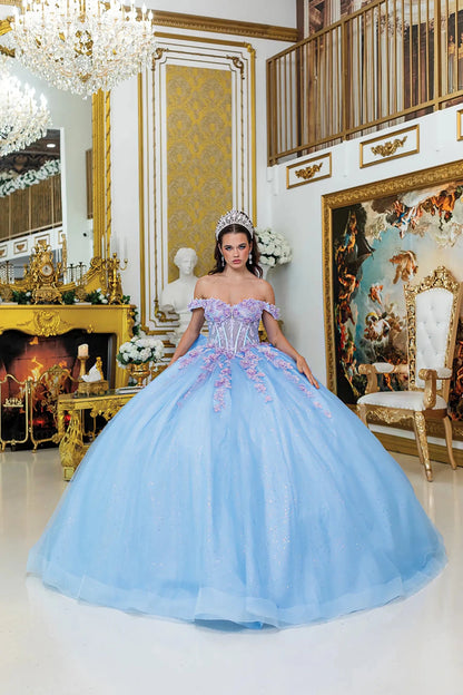 Woman standing front-facing in Bahama-lilac quinceañera ball gown with corset bodice, off-shoulder floral details, 3D embellishments, and voluminous glitter tulle skirt