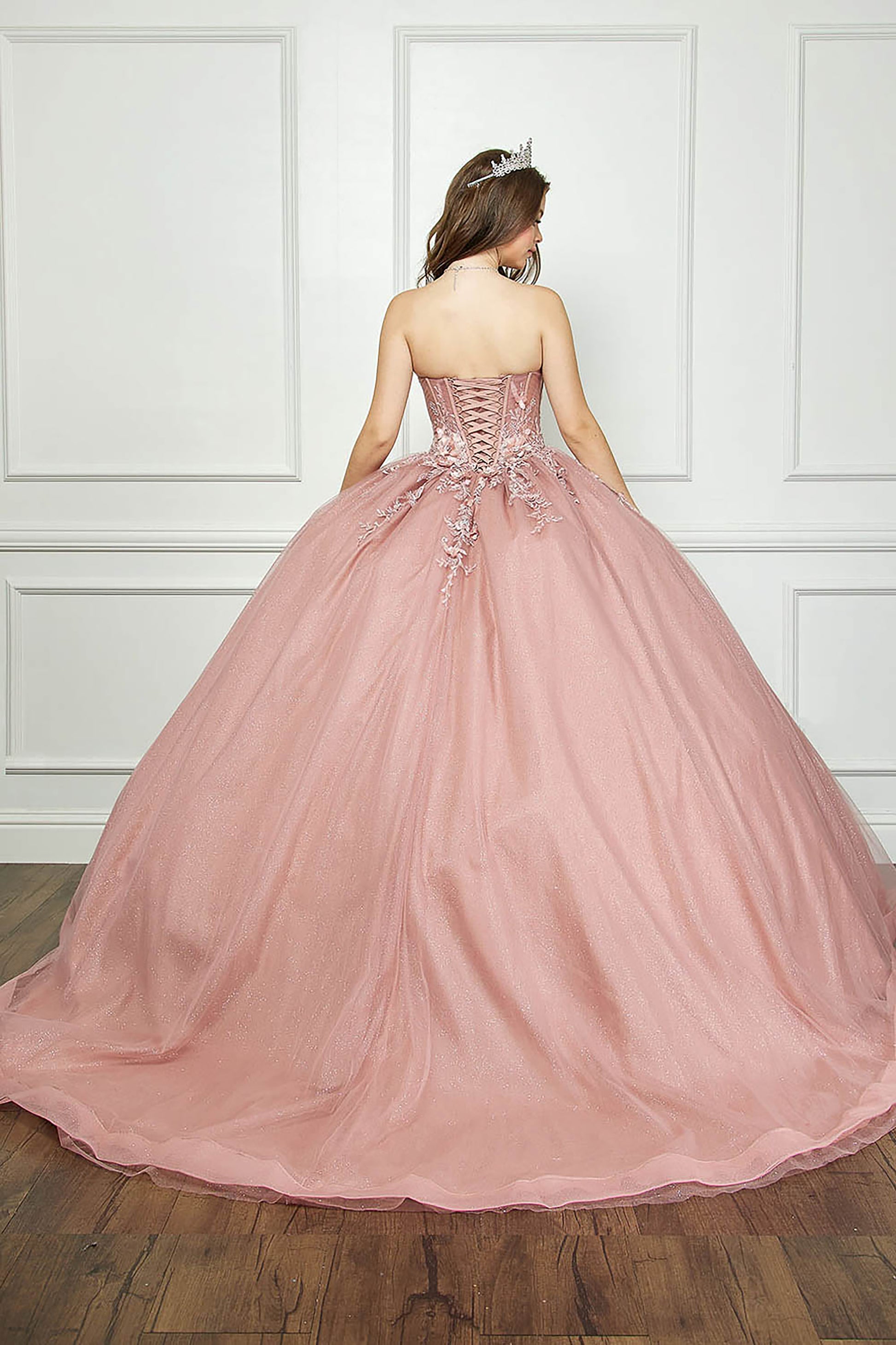 Dusty Rose Off-shoulder 3D Flowers and Gems Ballgown with removable sleeves - back view of woman wering dress with crown on head and hands at sides