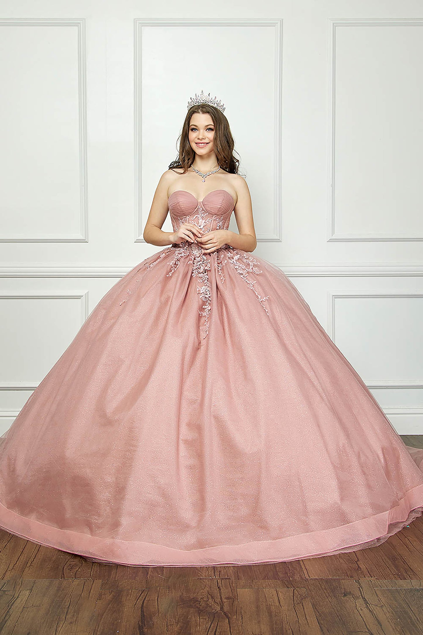 Dusty Rose Off-shoulder 3D Flowers and Gems Ballgown with removable sleeves - front view of woman wering dress and crown with hands folded in front of her