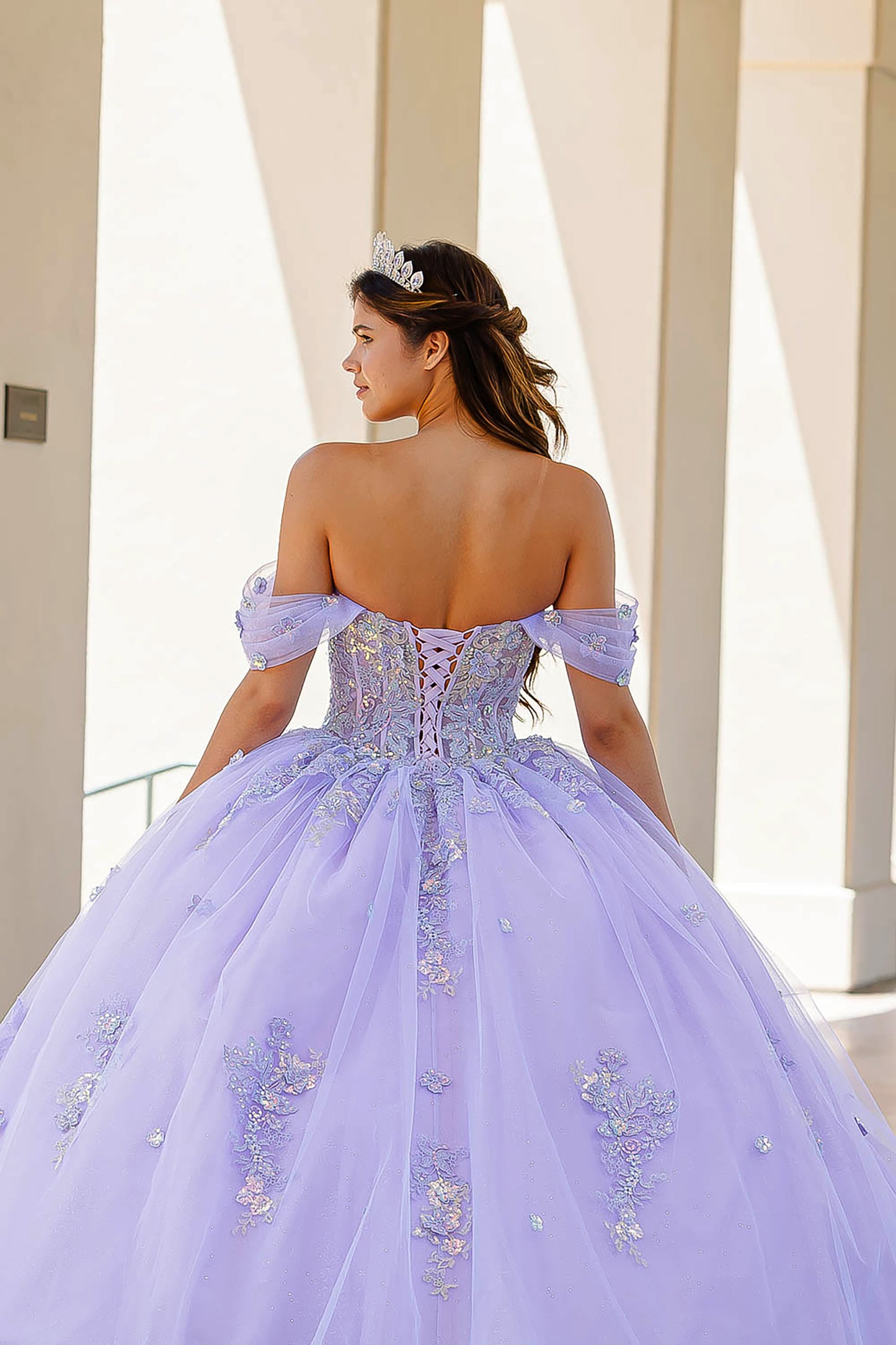 Quinceanera | Lilac Two-Tone See-Through Shimmering Sequins and 3D flowers Bodice Ballgown - back view of woman wearing dress and crown