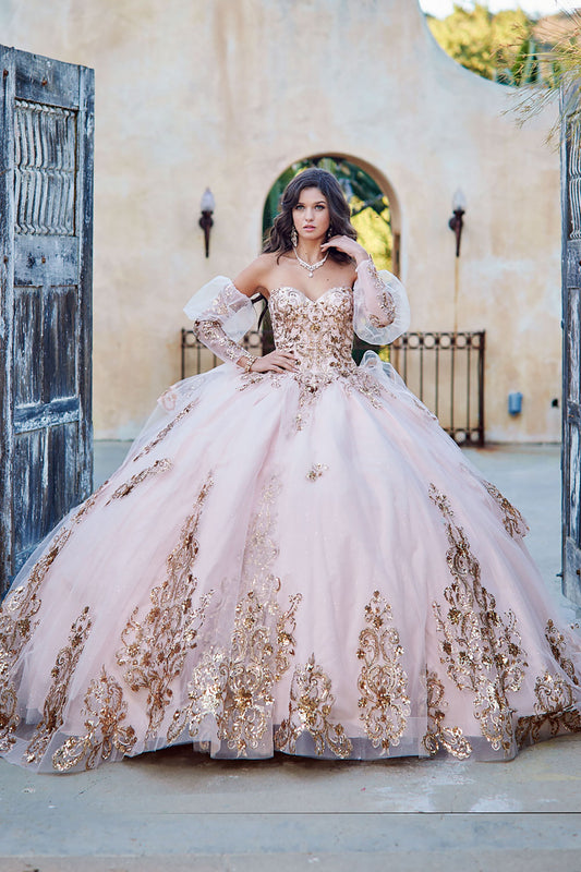 Quinceanera | Detachable Puffy Sleeve Champagne Ballgown | Gold Embroidered and Sequin Bodice Quince dress - front view of woman wearing dress with one hand by neck and the other hand on waist