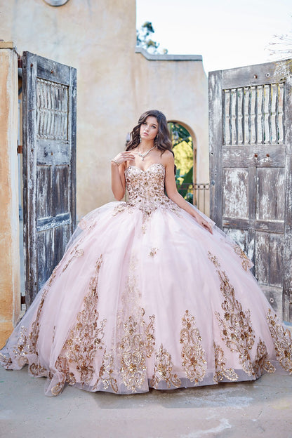 Quinceanera | Detachable Puffy Sleeve Champagne Ballgown | Gold Embroidered and Sequin Bodice Quince dress - front view of woman wearing dress with one hand near necklace