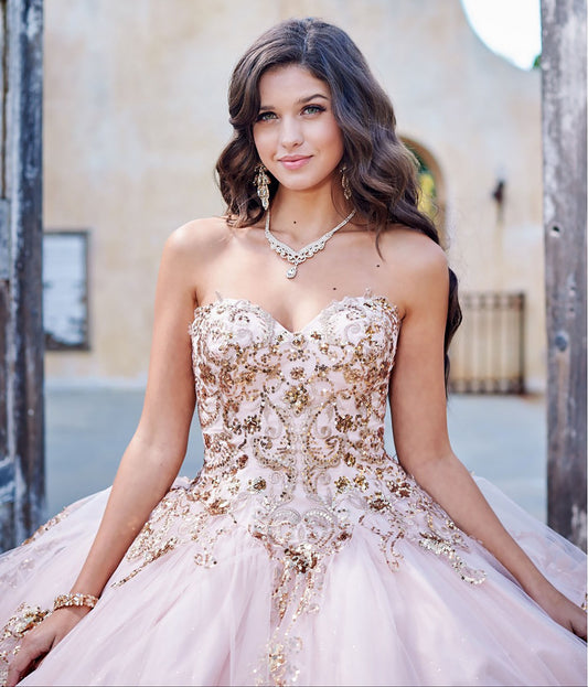 Quinceanera | Detachable Puffy Sleeve Champagne Ballgown | Gold Embroidered and Sequin Bodice Quince dress - zoomed in front view of woman wearing dress and smiling