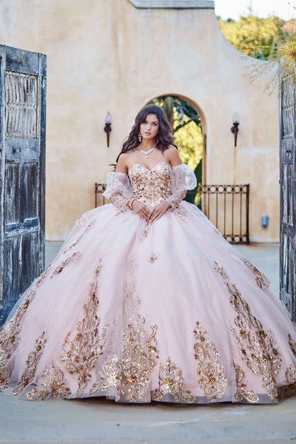 Quinceanera | Detachable Puffy Sleeve Champagne Ballgown | Gold Embroidered and Sequin Bodice Quince dress - front view of woman wearing dress with both hands clasped in the front