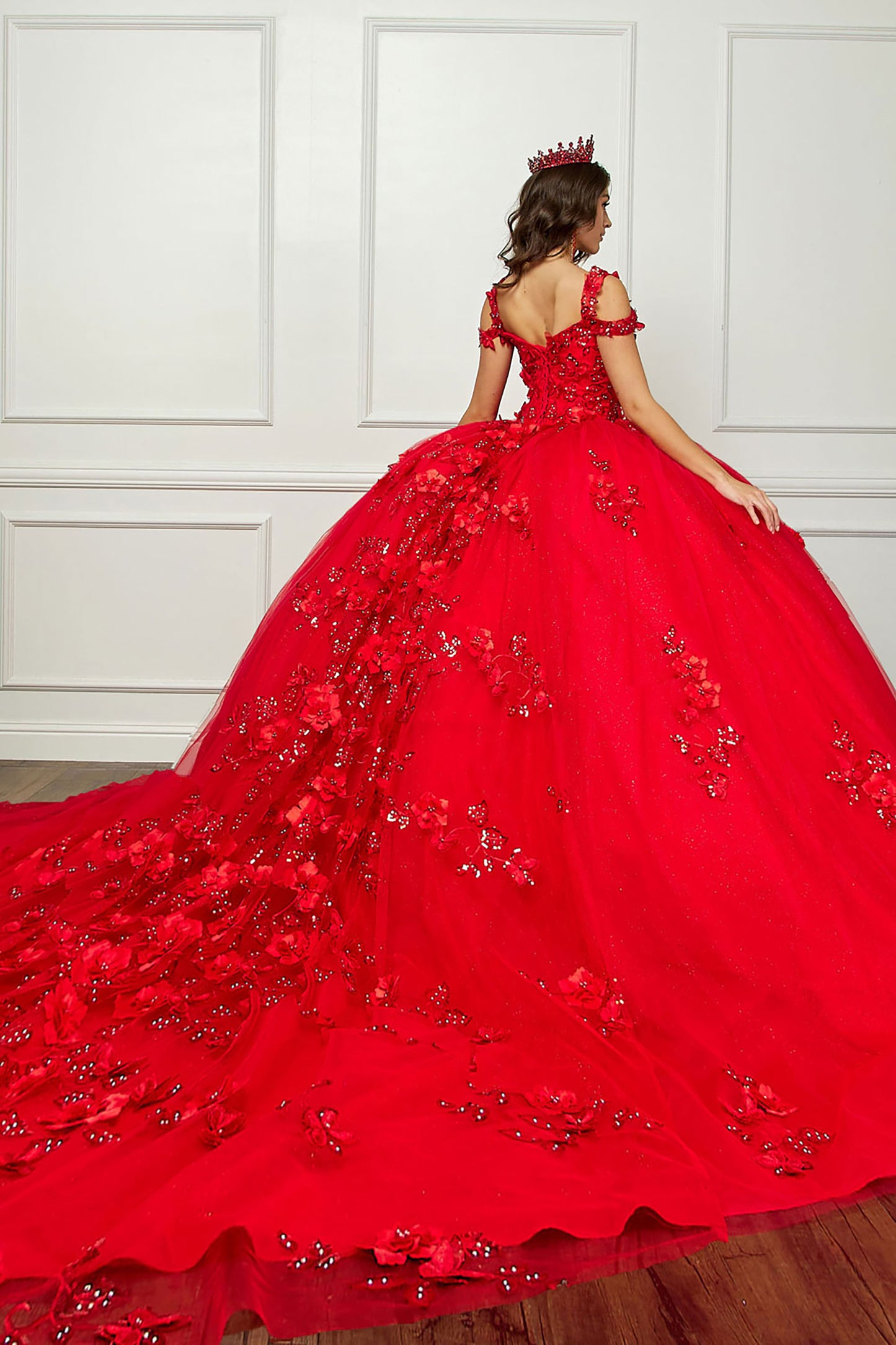 Red Long Train Off-Shoulder Sequin detail 3D Flower and Butterflies bodice with Sparkle Tulle Quince Dress - back view of woman wearing dress and red crown