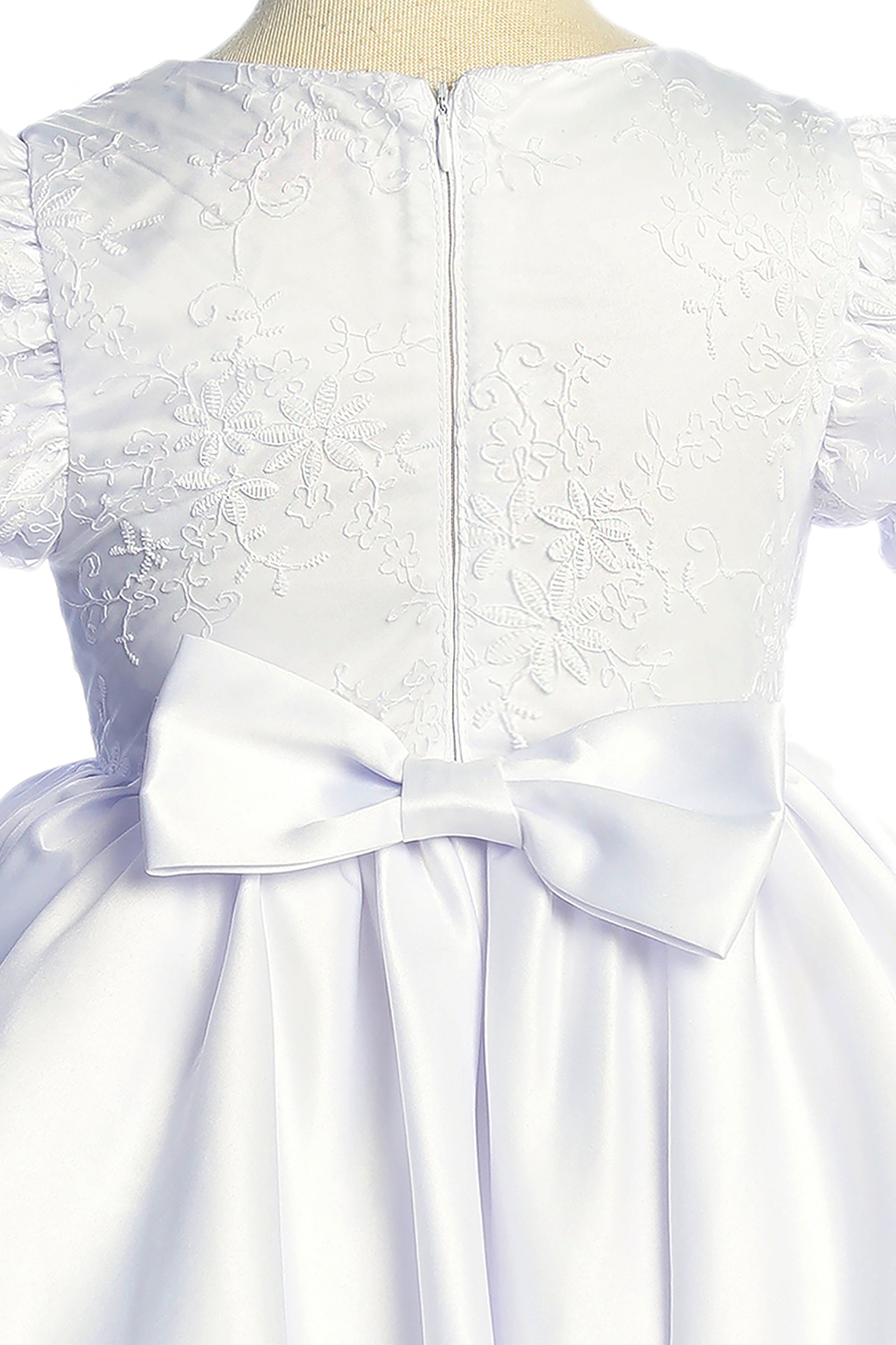 White lace dress with a large bow on a mannequin