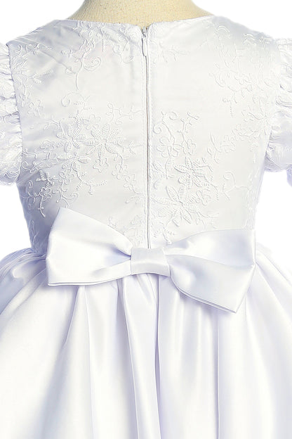 White lace dress with a large bow on a mannequin