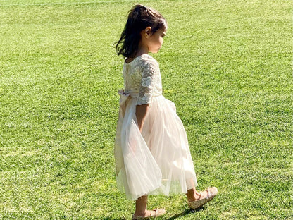 Champagne USA Made | 3/4 sleeve Lattice Flower Embroidered Lace with Satin & Crystal Tulle Flower Girl Dress - side view of girl wearing dress walking through the grass