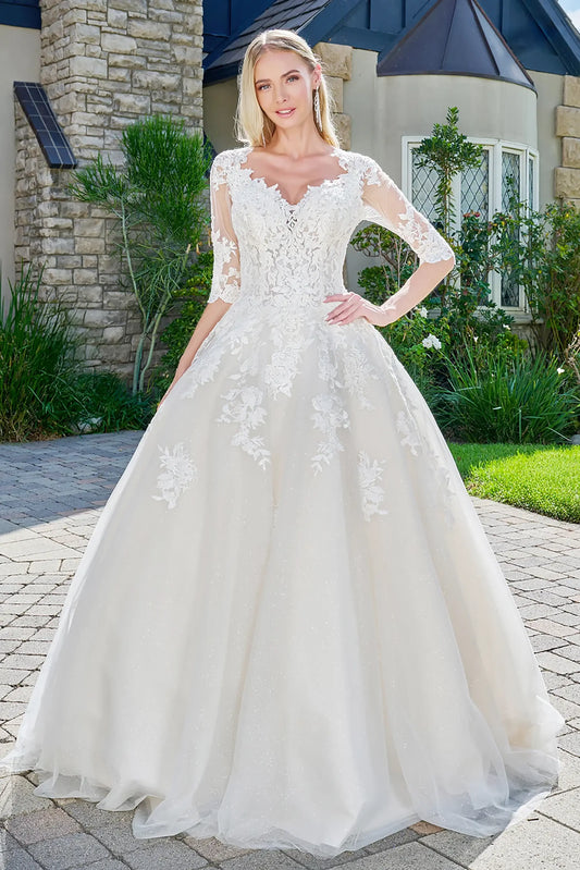 Front full-length view of an ivory and cream ball gown featuring a V-neckline, half sleeves with beads and jewels, and voluminous embroidered glitter mesh.