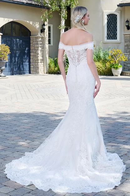 Back full-length view showcasing the dramatic flared mermaid skirt and the refined transition from the jeweled bodice to the flowing bridal train.