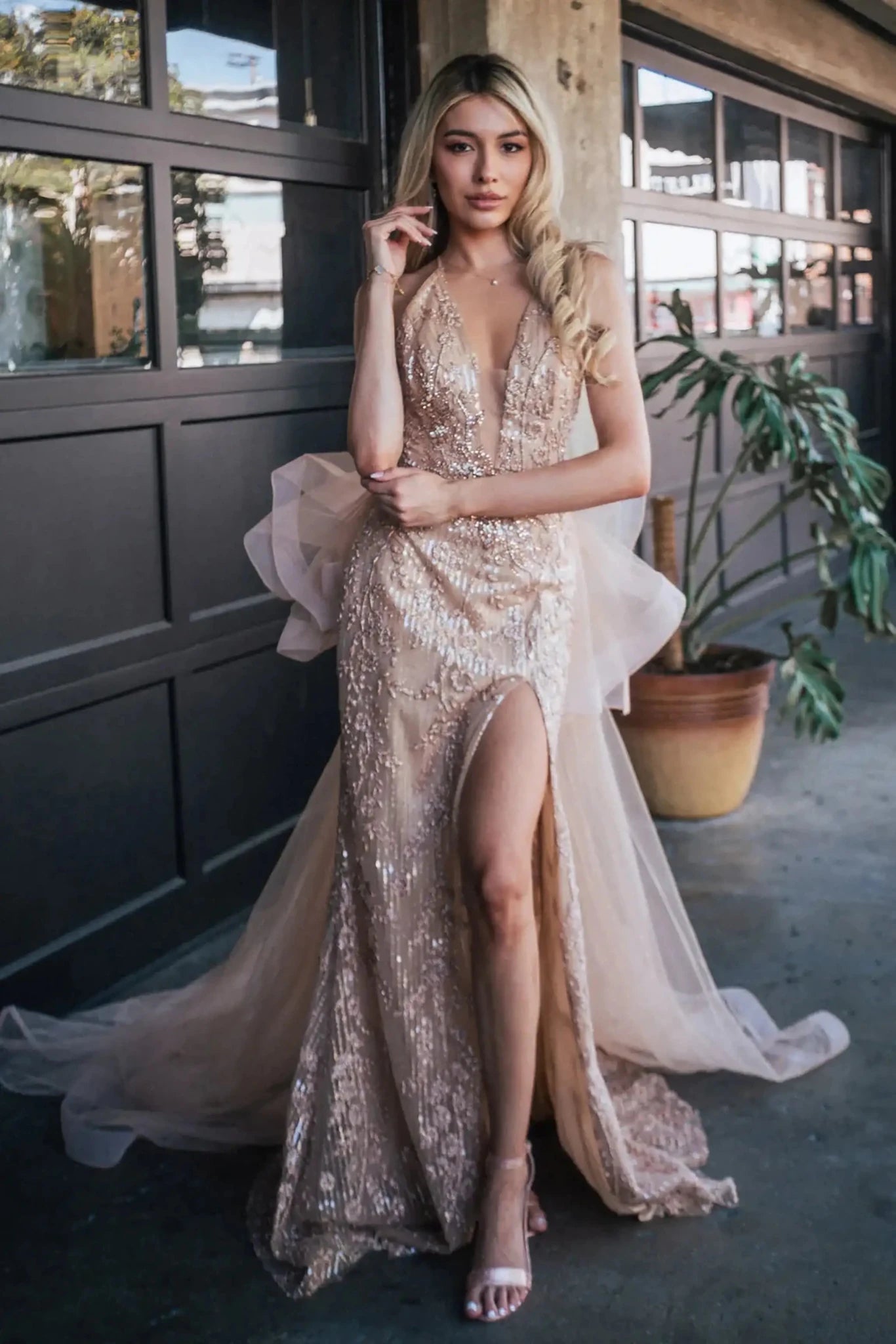 Front full-length view of a  Gold jewel-embellished mermaid prom dress with side slit and detachable mesh layer