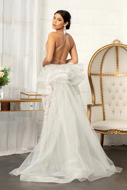 Back full-length view of of a  Silver & Nude jewel-embellished mermaid prom dress with side slit and detachable mesh layer