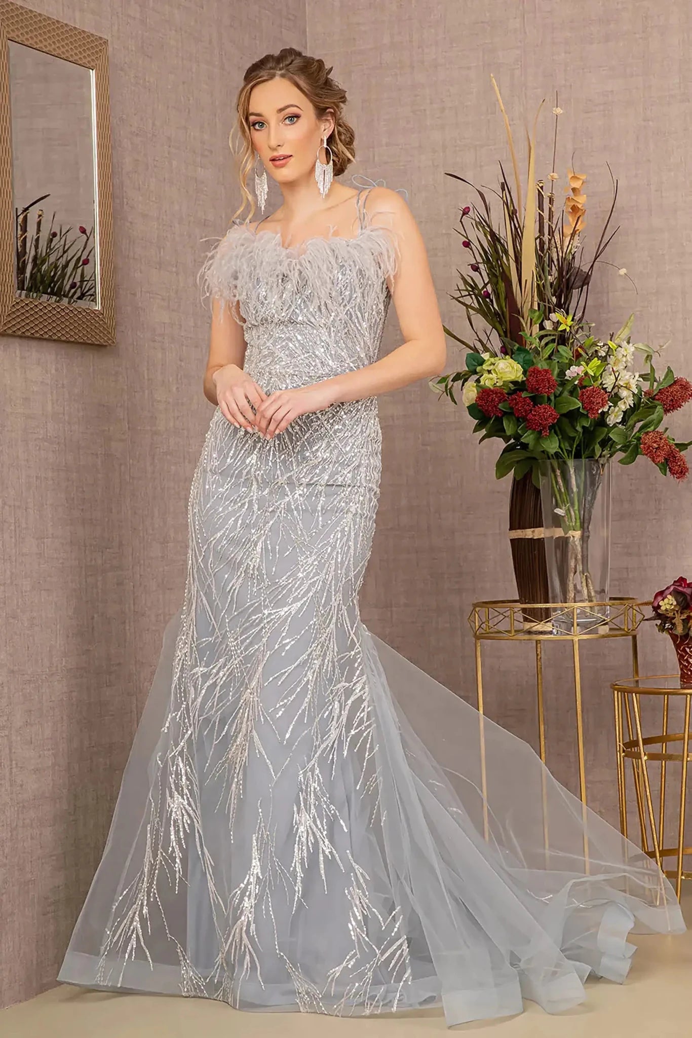 Front full-length view of a  Silver sequin sweetheart trumpet prom dress with feather embellishments