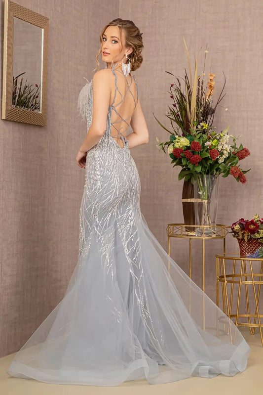 Back full-length view of of a  Silver sequin sweetheart trumpet prom dress with feather embellishments
