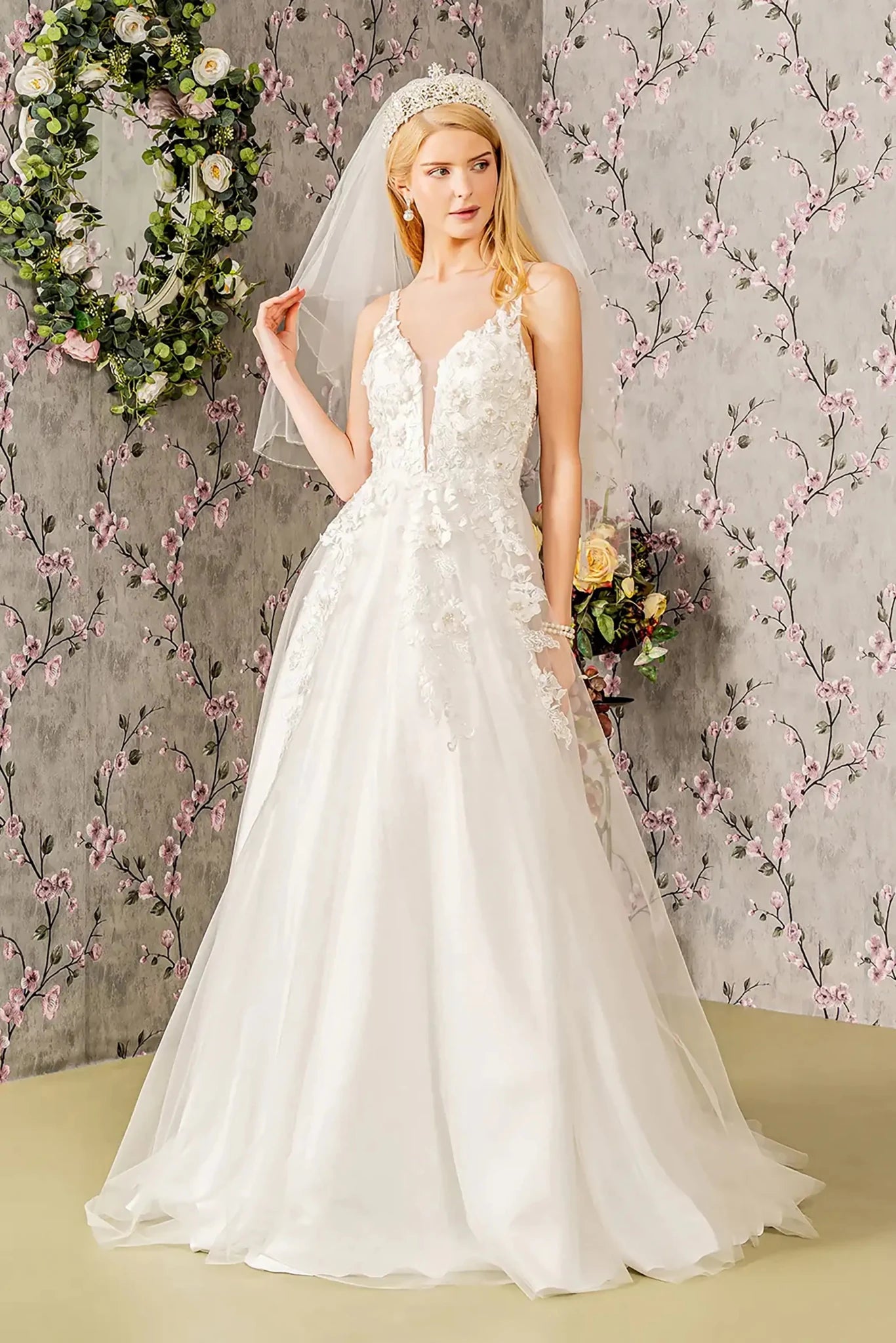 Front full-length view of a white A-line wedding dress featuring an illusion sweetheart neckline, supportive straps, and a voluminous skirt.