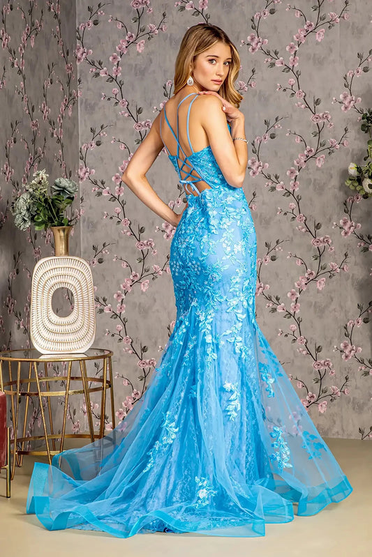 Back full-length view of of a  Ocean blue mermaid prom dress with sheer bodice and floral sequin embroidery