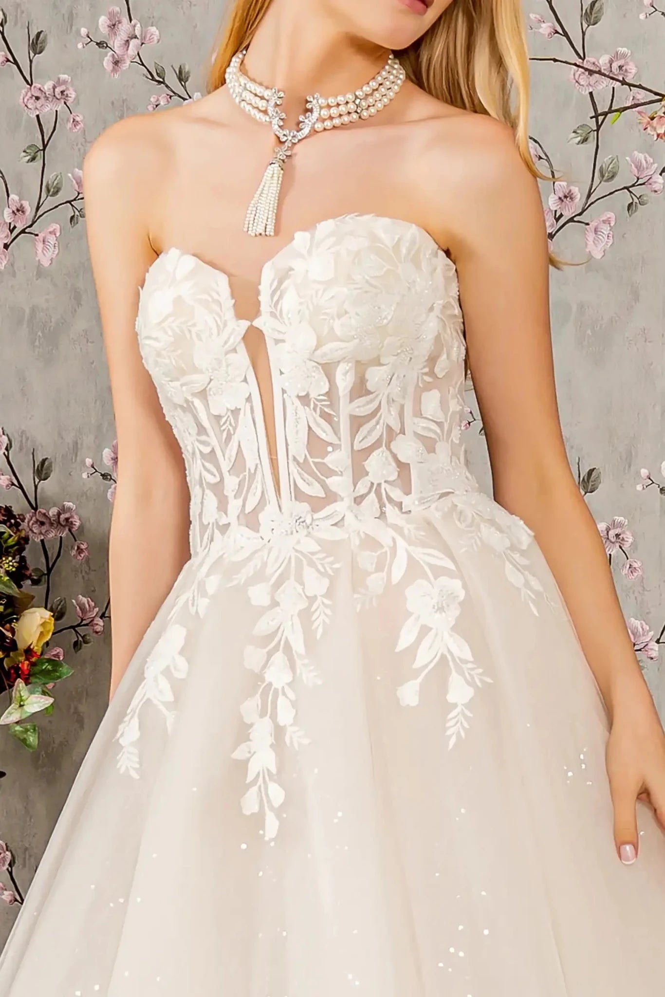 Front close-up upper view highlighting the intricate beaded embroidery and scattered sequins that decorate the translucent bodice, emphasizing the romantic sweetheart shape.